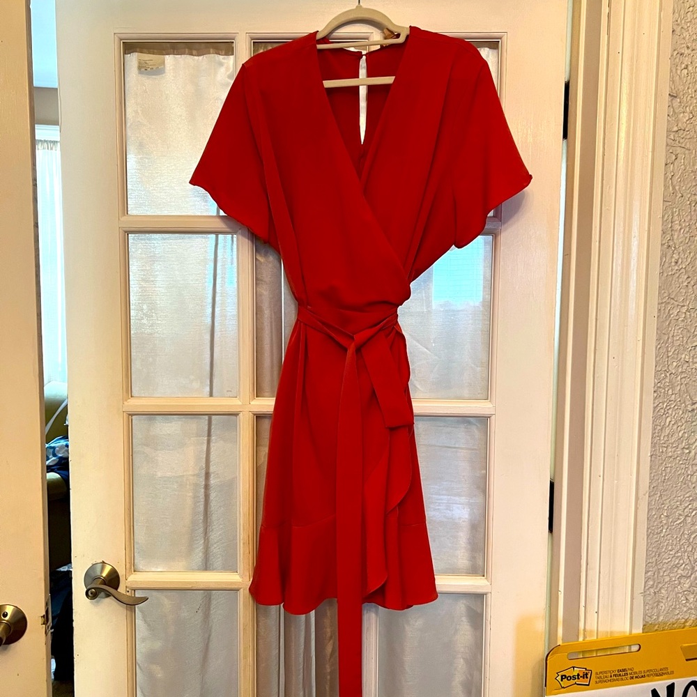 Flirty, rose wrap-dress with large single ruffle at bottom and side seam